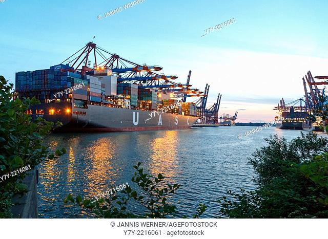 Ships moored at the Eurogate and Burchardkai container terminals in the port of Hamburg, Germany, at sunset in summer