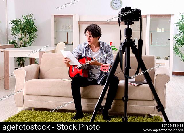 The young guitar player recording video for his blog