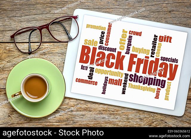 Black Friday word cloud - holiday shopping concept on a digital tablet with a cup of coffee