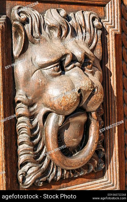 Lion head wood carving on old wooden door. Decorate detail