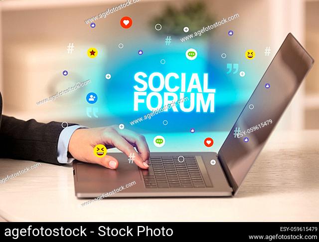 Freelance woman using laptop with SOCIAL FORUM inscription, Social media concept