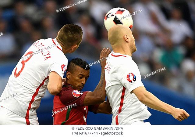 Artur Jedrzejczyk (L) and Michal Pazdan (R) of Poland and Nani (C) of Portugal vie for the ball during the UEFA EURO 2016 quarter final soccer match between...