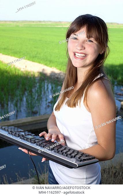 Woman with a computer keyboard in her hands