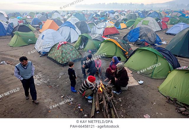 Refugees sitting at a fire outside their tents in the refugee camp near the Greek-Macedonian border near Idomeni, Greece, 06 March 2016