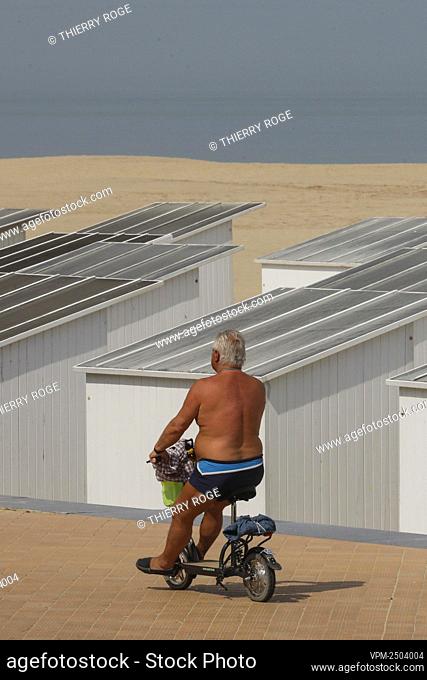 Illustration picture shows a man riding an electric scooter at the Belgian coast in Oostende, as people flock to the beach for the long Ascension weekend