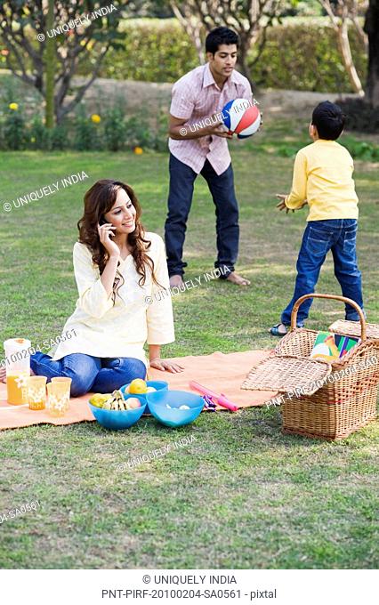 Family enjoying picnic in a garden, Gurgaon, Haryana, India