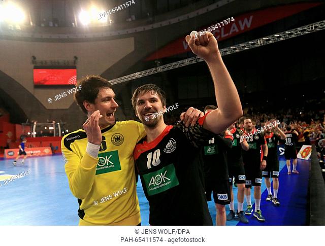 Germany's goal keeper Andreas Lichtlein (L) and Fabian Wiede celebrate after winning the 2016 Men's European Championship handball group 2 match between Germany...