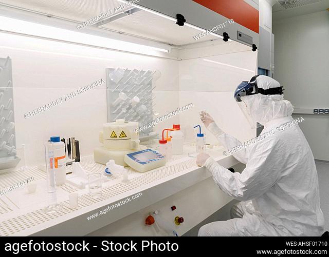 Researcher wearing safety helmet working in laboratory