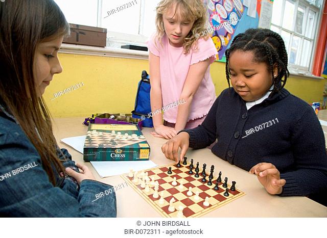 Primary school children playing a game of chess in an after school club