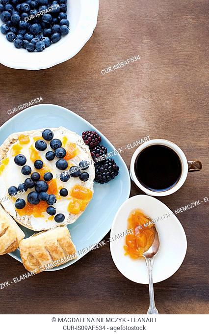 Dessert with blueberries, jam and black coffee