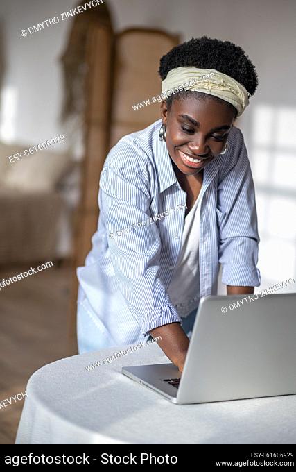 Work from home. African american woman working on laptop from home