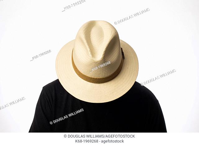 a man wearing a straw fedora hat over his face