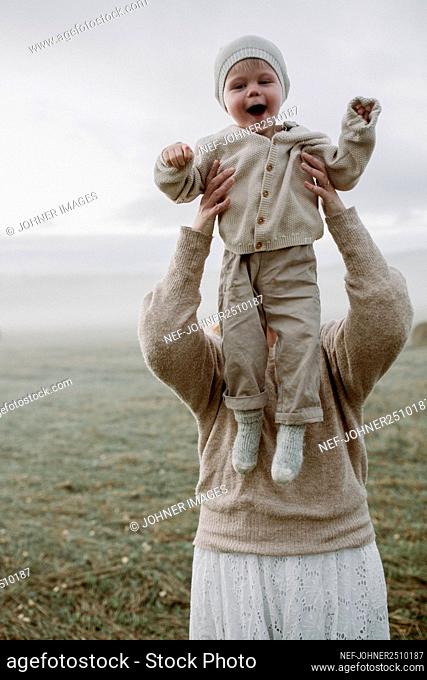 Woman with baby posing in field