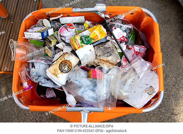 12 August 2019, Berlin: The content of a typical street waste bin with numerous packages, disposable cups and residual waste is presented at a press conference...