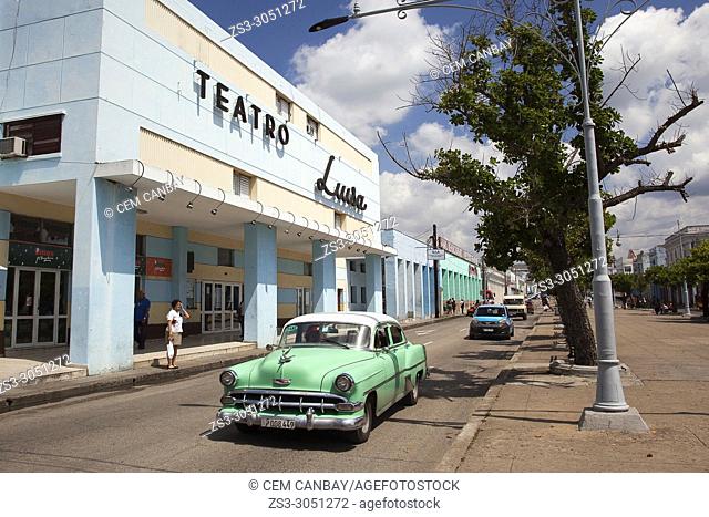 Old American car on Paseo Del Prado in front of the Teatro Luisa in the city center, Cienfuegos, Cienfuegos Province, Cuba , Central America