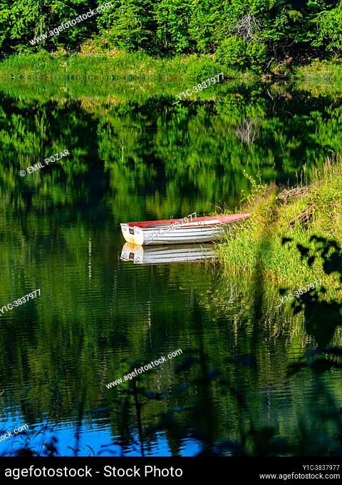 Boat on coastline of lake Lokve in Croatia in morning