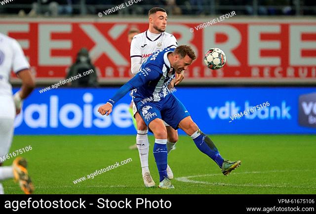 Anderlecht's Zeno Debast and Gent's Laurent Depoitre fight for the ball during a soccer match between KAA Gent and RSC Anderlecht, Sunday 05 March 2023 in Gent
