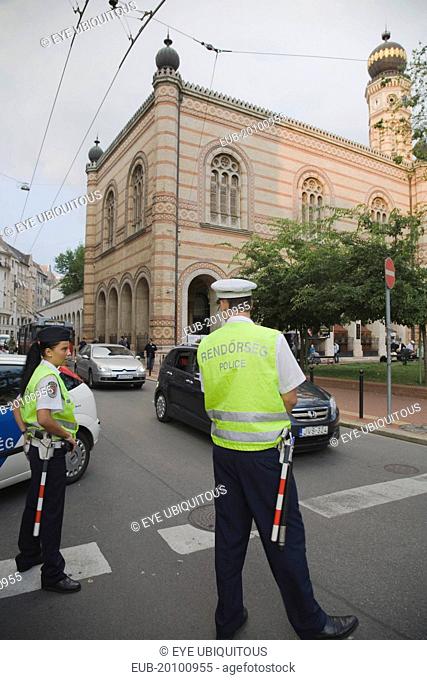 Hungarian traffic police wearing high visability jackets on road outside The Great Synagogue also known as Dohany Street Synagogue