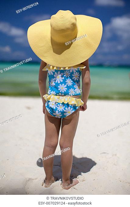 baby girl in her sun hat on the beach