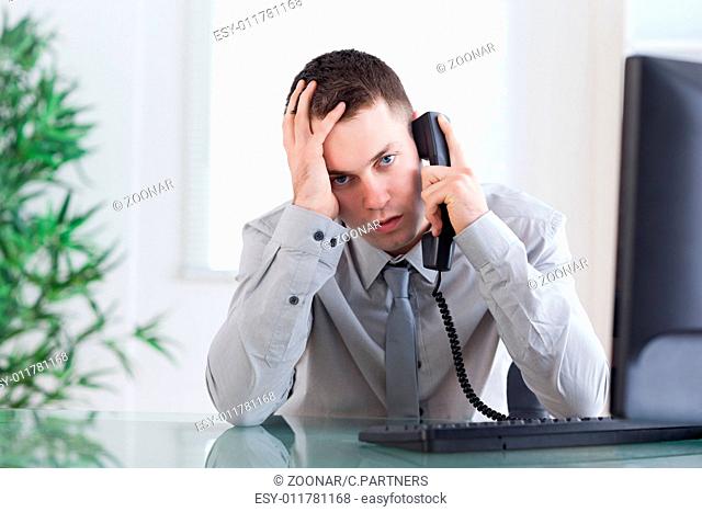 Close up of businessman getting sad news on the phone