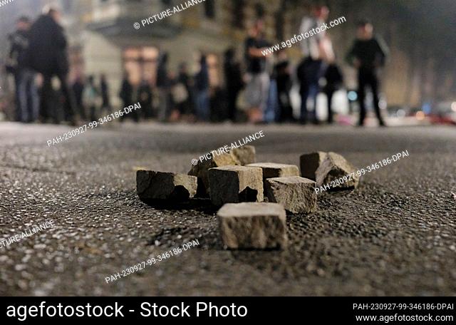 26 September 2023, Saxony, Leipzig: Torn out cobblestones lie on a street. Riots broke out during a left-wing protest against the eviction of a squatted house