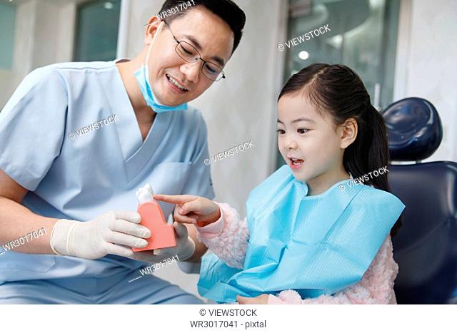 Cute little girl and dentist