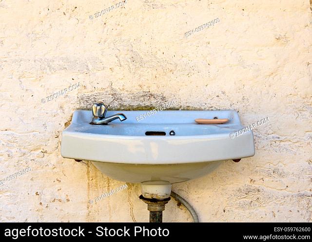 Outdoor sink and dirty wall