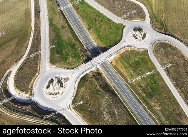 Aerial drone view over a country road junction intersection. Traffic on flyover at rural scenery. High quality photo