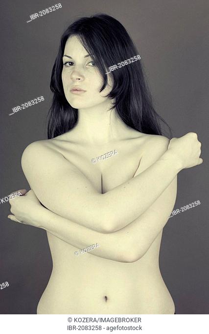 Woman, naked upper body, embracing herself
