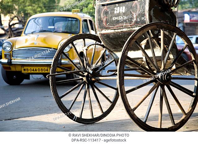 Street scene ; hand rickshaw's two wheels ; Calcutta now Kolkata ; West Bengal ; India