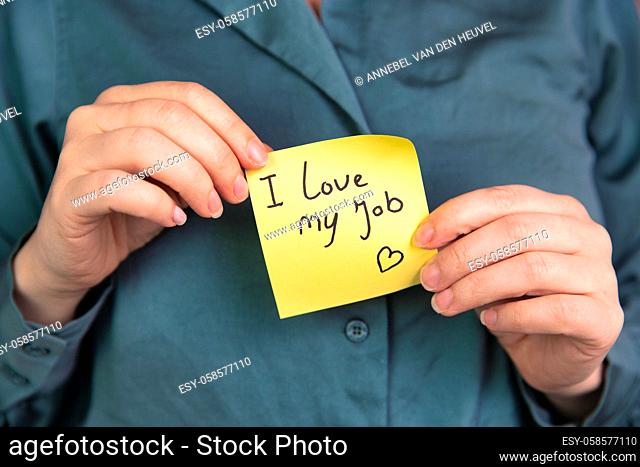 I Love My Job Note in hand, business woman or man with yellow sticky note with positive achievement, business, goals, education, people concept