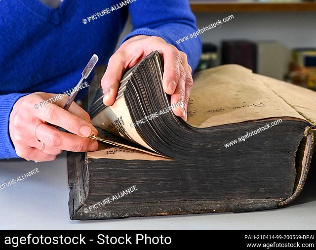 13 April 2021, Berlin: In the paper workshop Friedrichshagen a bible ""The whole Holy Scripture"" from the year 1737 is repaired