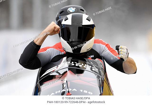 Justin Kripps and Alexander Kopacz of Canada cross the finish line in the 2-man event at the Bobsleigh World Cup in Schoenau am Koenigssee, Germany