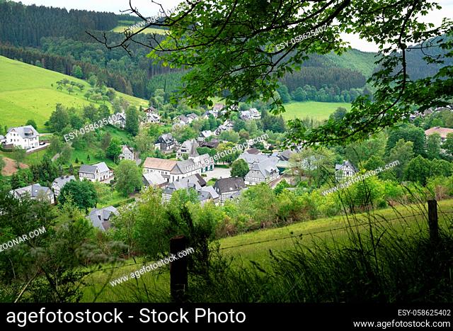 Panoramic image of a small village close to Winterberg with meadows, hills and trees, Sauerland region, Germany