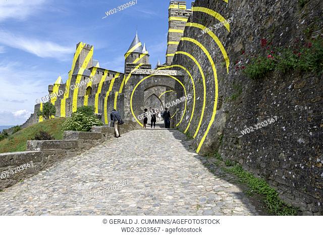 To celebrate the 20 years of its classification at UNESCO, The French town of Carcassonne couvered the walls of itâ. . s medieval city with circles of yellow...