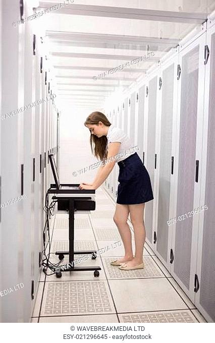 Woman is working on the servers in the data center