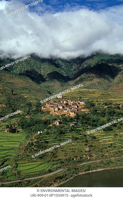 RURAL LANDSCAPE, BHUTAN. WANDIPHODRANG VILLAGE. Most of Bhutan is mountainous. Houses are surrounded by terraced fields.