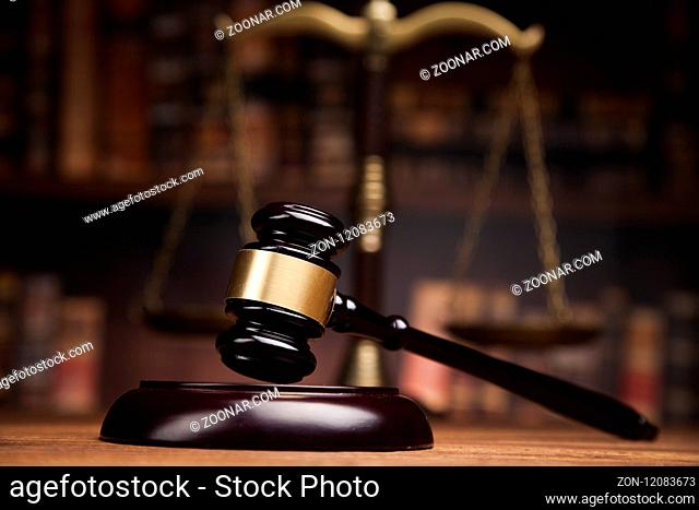 Law theme, mallet of the judge, wooden desk, books