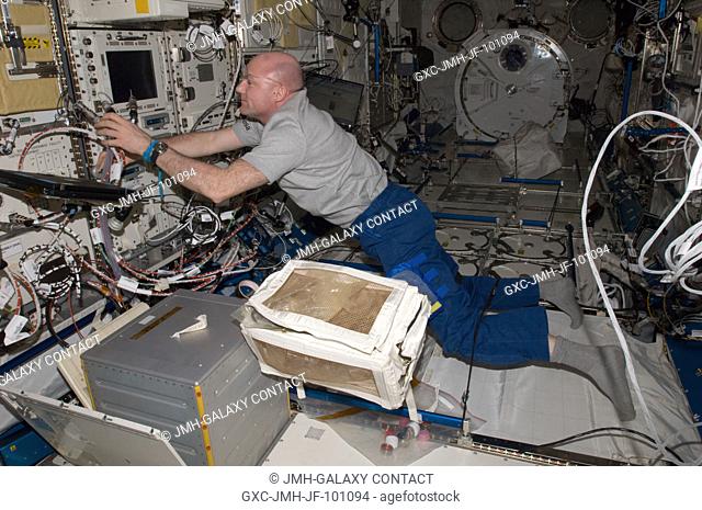 European Space Agency astronaut Andre Kuipers, Expedition 31 flight engineer, works with the Ryutai Rack in the Kibo laboratory of the International Space...