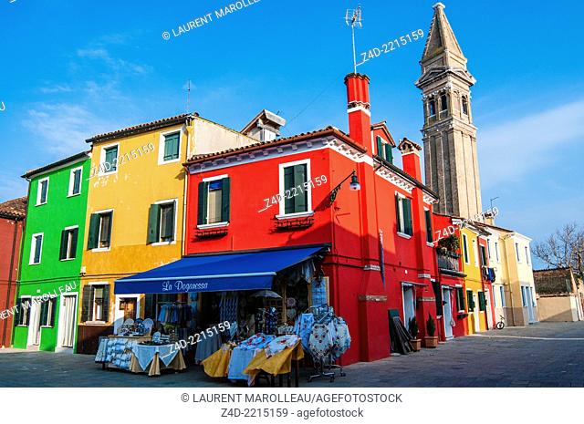 San Martino church, Street and colorful houses on island Burano. Venice, Veneto region, Italy, Europe