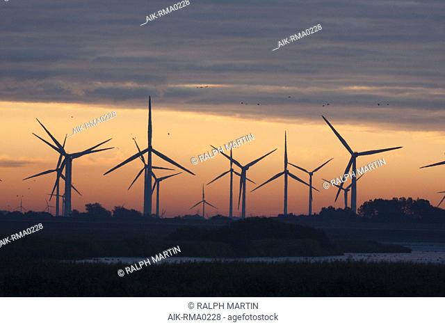 Wind farm at dusk in Germany. With pink colored sky in the background