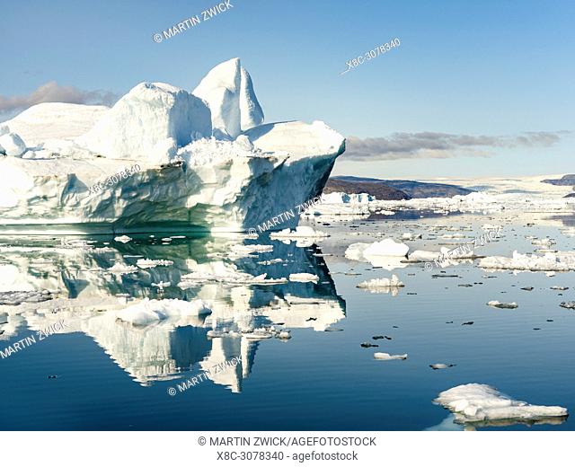 Icebergs in the Uummannaq fjord system in the north of west greenland. Glacier Lille Gletscher and the ice cap in the background