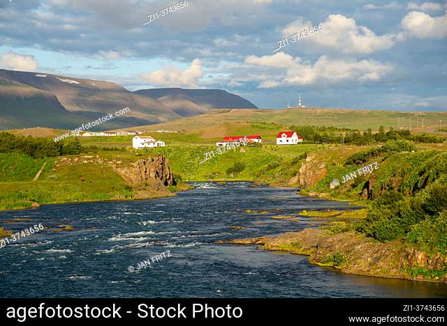 wild river with houses on Vatnsnes, Iceland