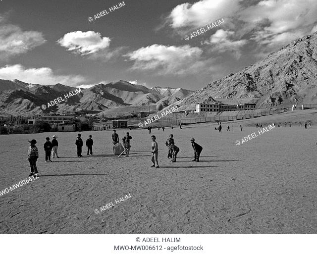 Young boys playing cricket in Ladakh land of high passes, in the state of Jammu and Kashmir, Northern India It is one of the most sparsely populated regions in...