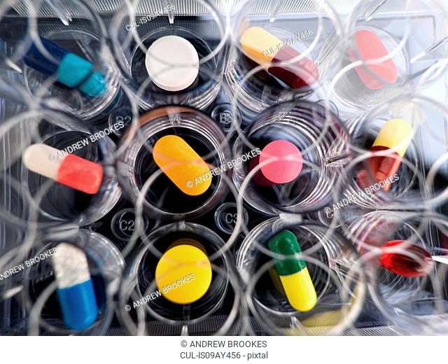 Pharmaceutical research, overhead view of variety of medical drugs in a multi well tray for laboratory testing