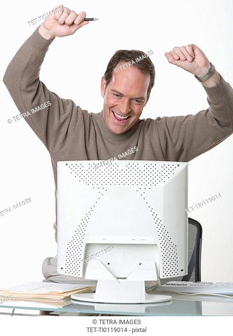 Exuberant man at his computer