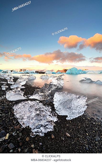 Jokulsarlon, Eastern Iceland, Iceland, Northern Europe. The iconic little icebergs lined in the glacier lagoon during a sunrise