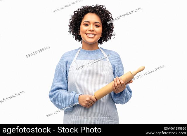 smiling woman in apron or baker with rolling pin