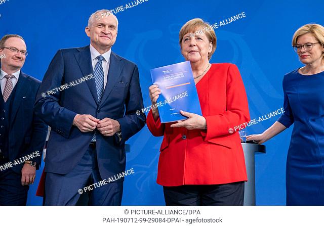 12 July 2019, Berlin: Federal Chancellor Angela Merkel (CDU) stands next to the Chairman of the Council of Experts Christoph M