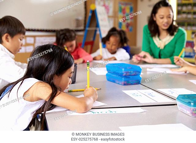 Teacher sitting with kids in elementary school lesson